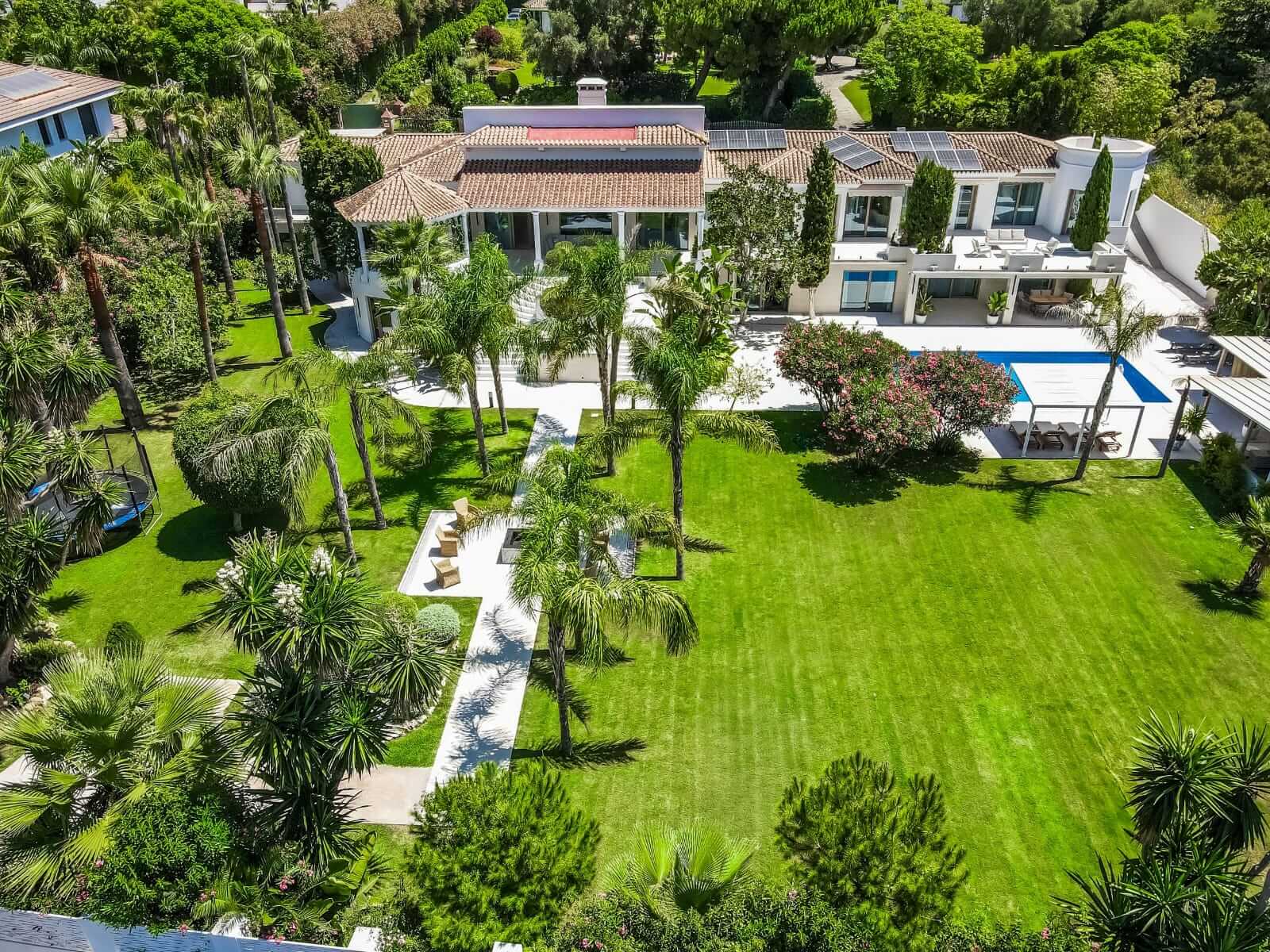 Aerial view of a modern villa with private garden and pool