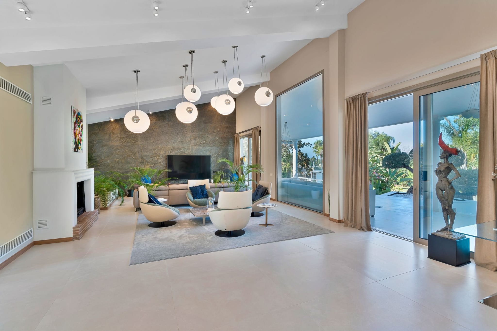Living room with high ceilings and garden views at Villa Magnolia