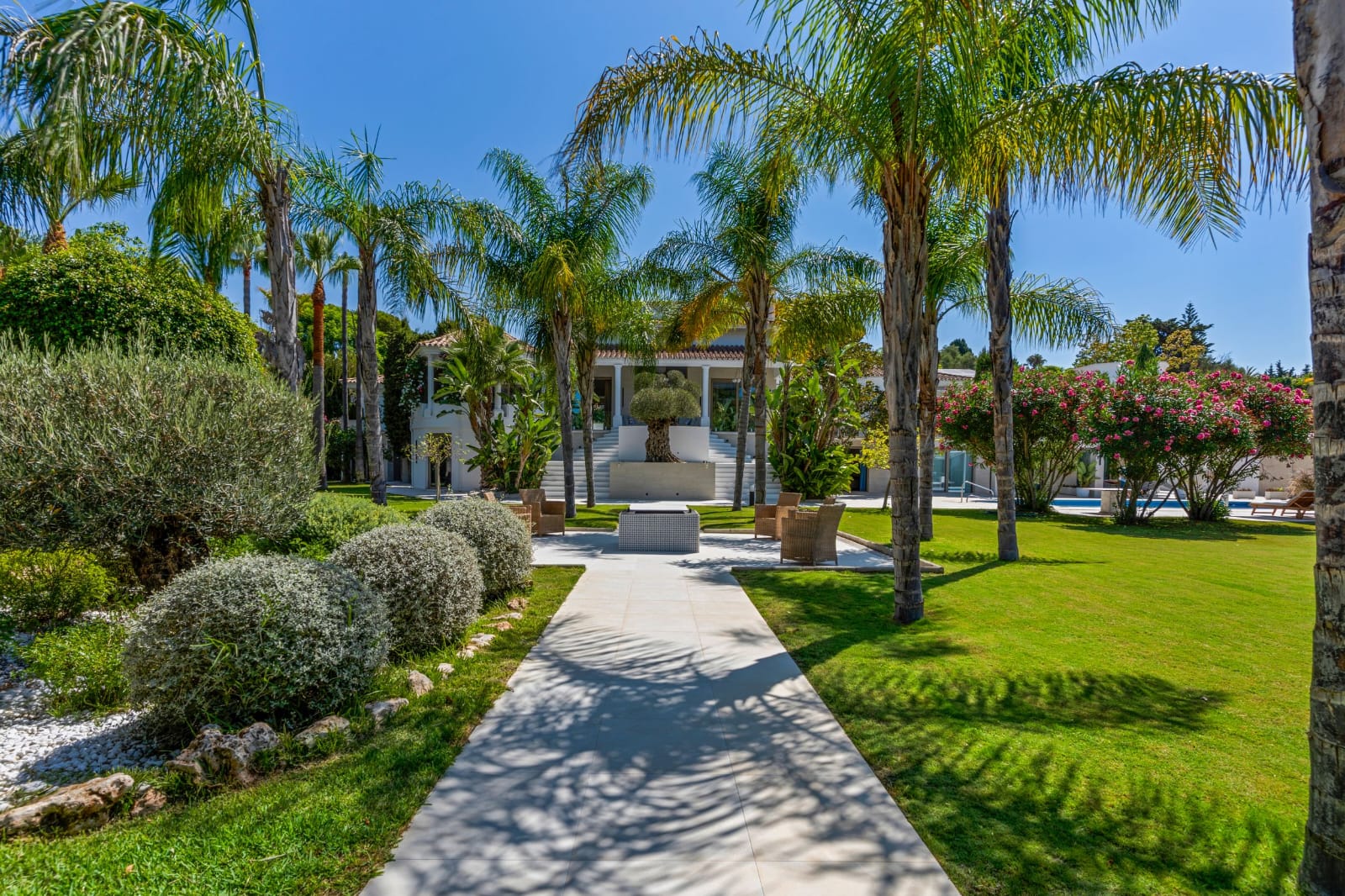Palm-lined garden path leading to Villa Magnolia